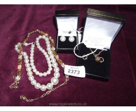 A pair of 9ct gold hallmarked pearl earrings, a 14ct gold plated necklace and pendant and earrings, a gold coloured pretty ne