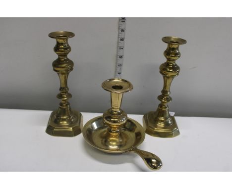 A pair of brass candlesticks &amp; chamber stick 