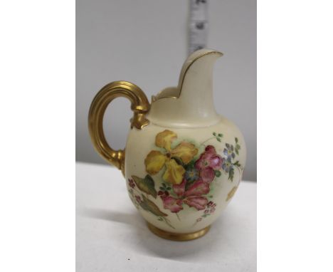 A Royal Worcester blush ivory lidded pot with hand painted flower decoration stamped 1286 to the base 