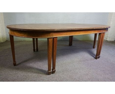 A vintage oak extending dining or serving table, (used as a textile cutting table a famous Scottish tartan weavers) with two 