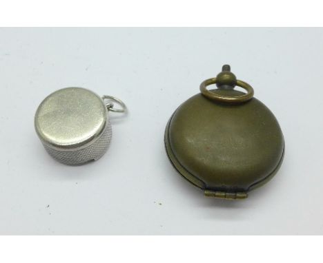 A silver coin holder and a compass