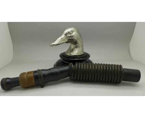 A duck caller, marked 'Scotch', Oakfield, N.Y. and a duck head paperweight