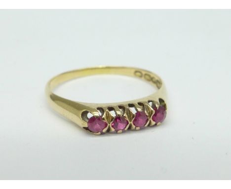 A 14ct gold ring set with four rubies, marked 585, 2.4g, R
