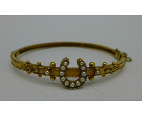 A Victorian 9ct gold and seed pearl bangle, Birmingham 1890, 6.7g