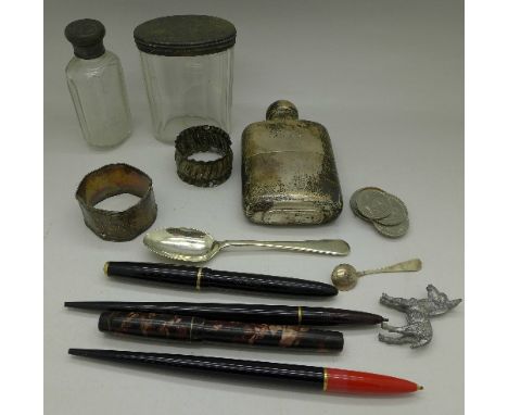 A silver hip flask, two silver napkin rings, a silver topped bottle and jar, a silver spoon, two ink pens with 14k gold nibs,