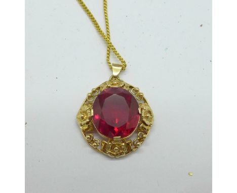 A 14ct gold and synthetic ruby pendant on a plated chain, weight of pendant 6g, continental marks