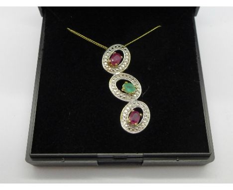 A silver gilt, ruby and emerald pendant