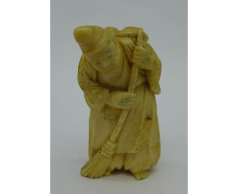 A Japanese carved ivory netsuke depicting man with broom, 52mm