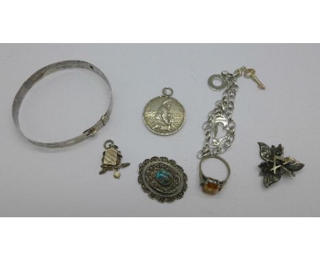 Silver comprising a charm bracelet, a ring, a turquoise pendant, a U.V.M., U.D.F. medal, a flower brooch and bangle, 46.1g