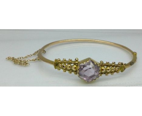A 9ct gold and amethyst bangle, 6.3g, mark worn