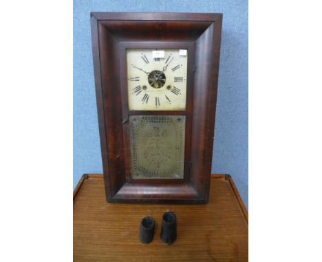 A 19th Century American mahogany weight driven ogee wall clock, by Brewster &amp; Ingrahams 