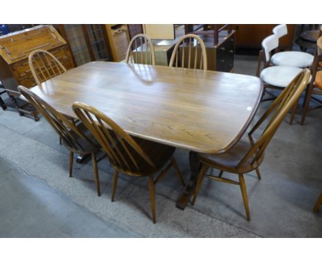 An Ercol Golden Dawn dining table and six Quaker chairs 