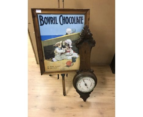 An easel and barometer; together with a Bovril Chocolate poster
