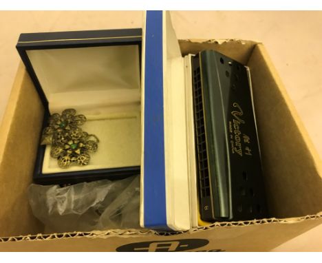 A quantity of dress jewellery, cased harmonica etc