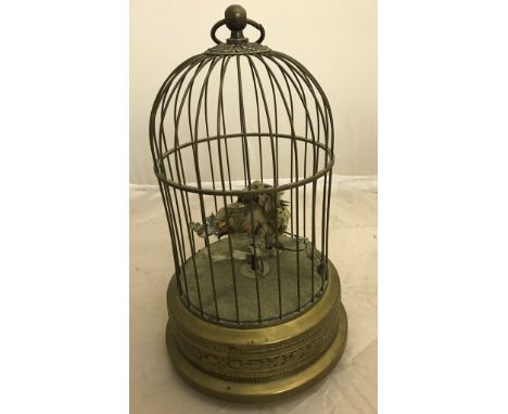 An early 20th century singing bird automaton in a brass cage