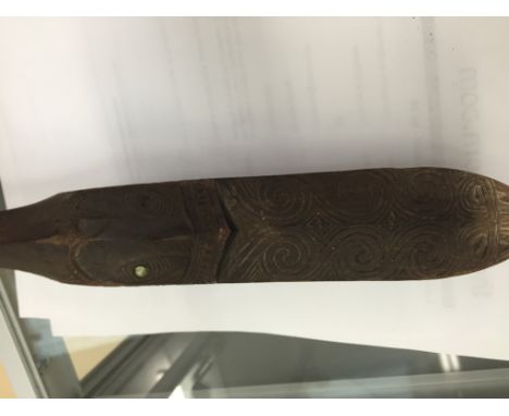 A 19th Century Tribal Patapatu Spear/Club:Head with a Maori design inlaid with mother-of-pearl eyes, the shaft having a diamo
