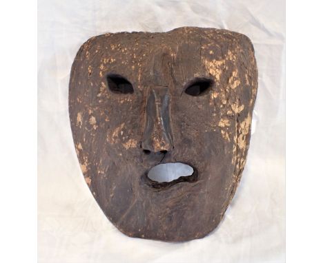 INUIT WOOD MASK, 19th century or earlier, probably depicting the ice spirit "Tupilak", 27cm x 25cm