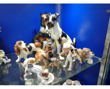 A ROYAL DOULTON STUDY OF A DOG, licking a plate and a collection of ceramic dogs (11)