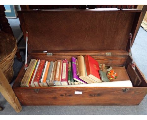 A COLLECTION OF BOOKS AND SUNDRIES contained in a wooden trunk and a wicker basket