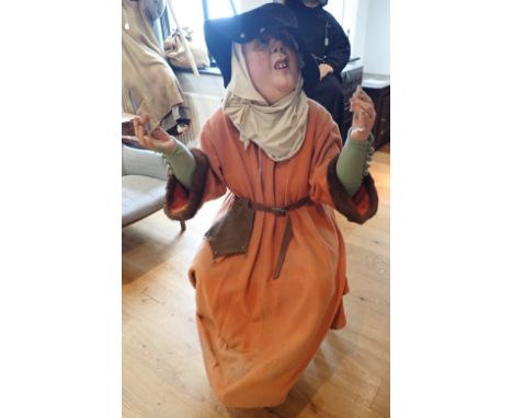 'THE CANTERBURY TALES' A FIBREGLASS STUDY OF 'THE WIFE OF BATH' (from The Wife of Bath's Tale) A seated figure with a compact