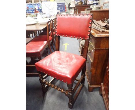 A SET OF 14 REPRODUCTION OAK CROMWELLIAN STYLE DINING CHAIRS with bobbin turning, upholstered in red leather with large brass