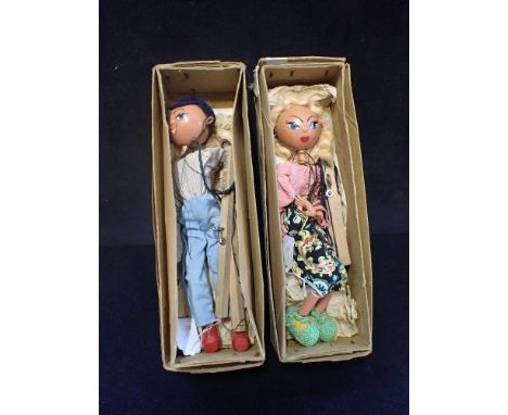 A VINTAGE PELHAM PUPPET OF A BLONDE GIRL and another of a boy, both with boxes