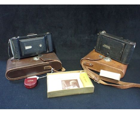 A KODAK CAMERA IN A LEATHER CARRYING CASE, together with one other Ikonta camera and accessories 