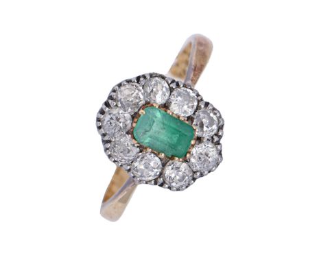 An emerald and diamond ring, the diamond cluster centred by a step cut emerald (5x4mm), gold hoop marked 18ct PLAT, 3.7g, siz