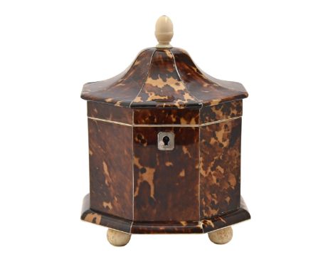 An early Victorian octagonal tortoiseshell tea caddy, wire stringing and silvered escutcheon, ivory knop and bone feet, the d