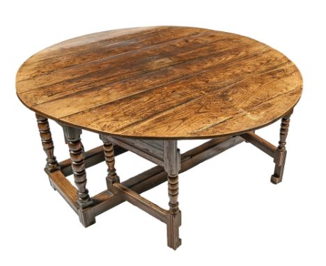 An unusually substantial oak gateleg table, with moulded frame and bobbin turned legs united by moulded stretchers, 78cm h; 1