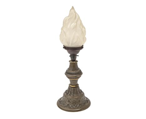 A stamped and lacquered brass oil lamp, c1900, adapted for electricity, with glass flambeau shade, 48cm h  Metal rim beneath 