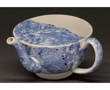 Medical antiques. An English blue printed earthenware spout cup, c1830, with a floral sheet print, 15cm l  Good condition