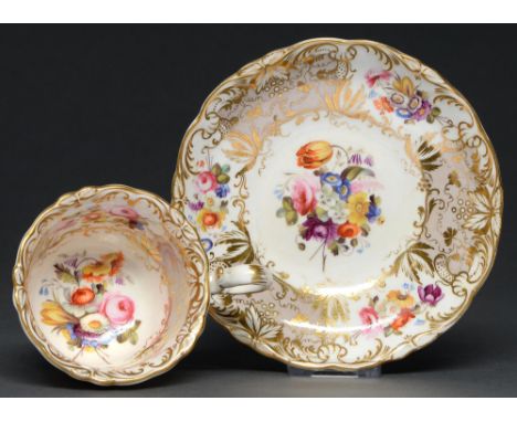 A Coalport coffee cup and saucer, c. 1830, painted with sprigs of country flowers, reserved on a grey and gilt scroll ground,