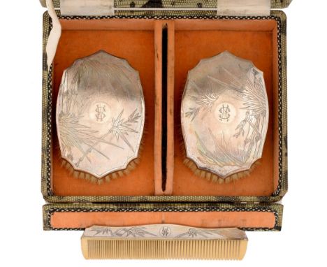 A pair of Chinese silver brushes and a comb, c1930, engraved with bamboo, cased  Good condition