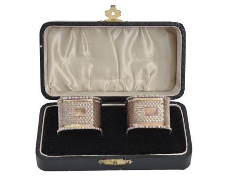 A pair of George V silver napkin rings, engine turned, by I S Greenberg &amp; Co, Birmingham 1933, cased, 2ozs 8dwts  As new,