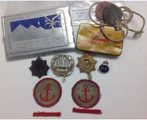 WWII British Army insignia lot
Dog tags, cap badges x three, trench art cigarette case 'Egypt 1946'.