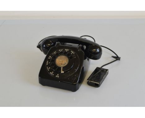 A black Bakelite rotary dial telephone, 706 model, circa 1961 with Stafford paper label