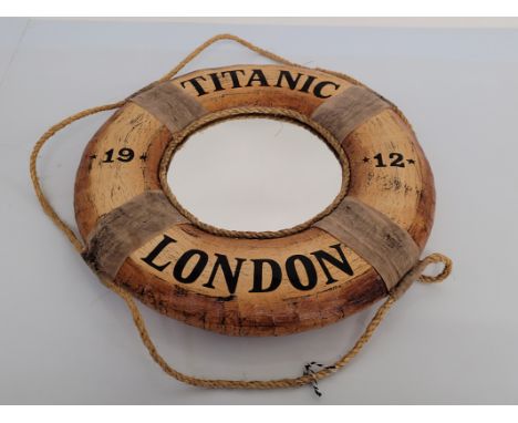 A novelty lifebuoy Titanic style mirror, circular shape with rope and cloth design, marked Titanic 1912, 45 cm diameter 
