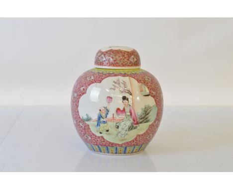 An early 20th century Chinese ginger jar and cover, with pink and yellow enamel tones, 19cm tall