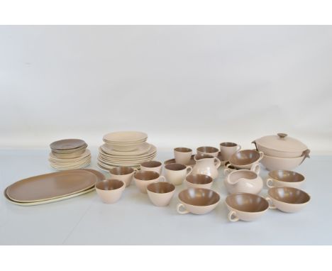 A Poole Pottery dinner service, two tone pink and brown, including tureens, soup bowls, cups, saucers, plates, chargers, etc.