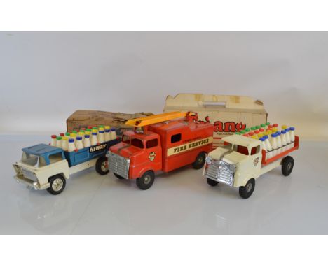 Two models from the Tri-ang Pressed Steel 'Junior Diesel' range including a boxed TM6115 Milk Lorry in red and white with ful