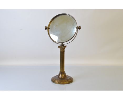 An early 20th century brass swivel mirror, 58cm tall.