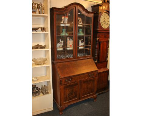 An Edwardian mahogany bureau bookcase, the top with domed cornice and three shelves enclosed by twin glazed panel doors, with