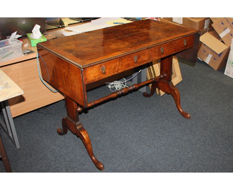 A walnut sofa table with cross banded top,  two frieze drawers and two opposing dummy drawers,  on outswept legs joined by tu
