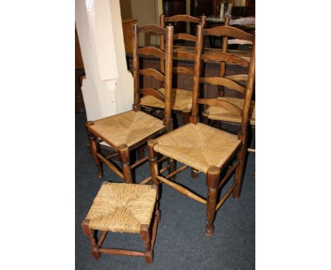 A set of four oak ladder back dining chairs with rush seats, and a rush seated footstool
