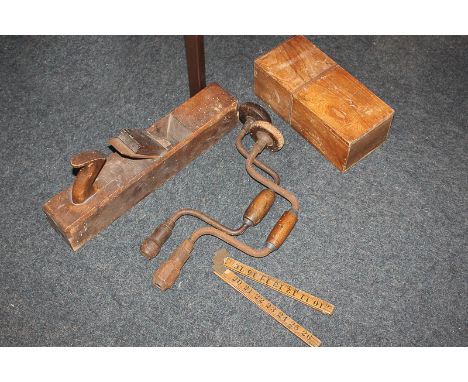 A small collection of tools comprising a plane, two hand drills, a box of drill bits and a folding ruler (a/f)