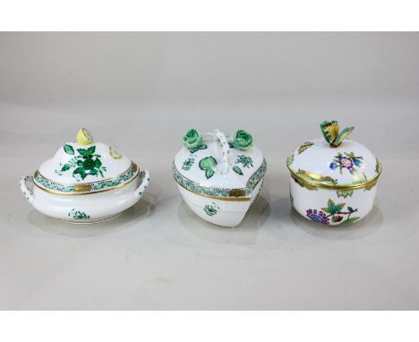 Three Herend porcelain pots and covers, one circular with butterfly finial, another oval in the green Chinese legend pattern 