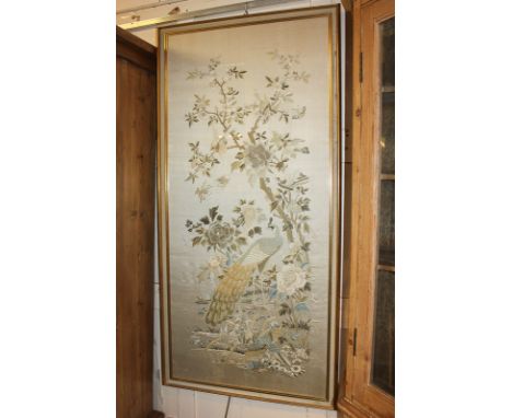 A Chinese silk embroidered panel depicting peacock, birds and butterflies amongst flowers and blossom, in glazed frame, panel