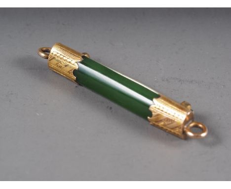 A jade bar brooch with yellow metal mounts 