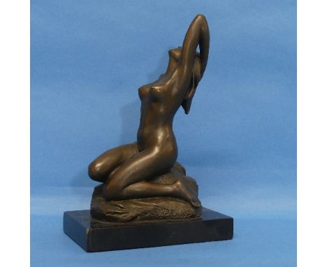 After J. Patoue (20th century), patinated bronze figure of a nude seated on a rock, impressed signature, on black marbled bas